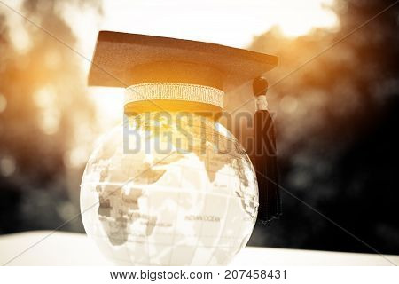 Education in Global Graduation cap on top model Earth. Concept of abroad international Educational Back to School and Studies lead to success in world wide.