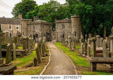 Aberdeen, Scotland, June 2017: Exit from St Machar cathedral and cemetery in summer