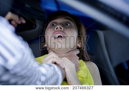 Theft squeeze woman's neck during driving a car back home. Robbery attacked her body vs pointing gun to her head. Thief extorted victim to release car. Unsafe vs high criminal in city. Thief concept