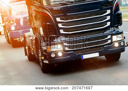 Trucks being driven on road picking up goods