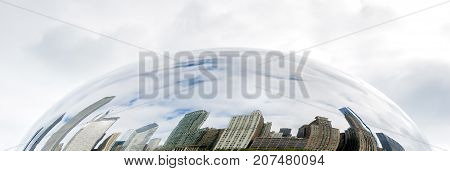 Chicago, IL, USA, october 28, 2016: Buildings of Chicago reflected on the Cloud Gate in a cloudy day