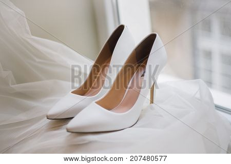 Elegant white wedding shoes for bride love