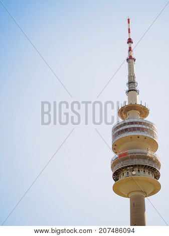 June 12 2017. Close-up view of the needle tip of the Olympiaturm also known as the Olympic Tower in the Olympiapark on a clear sunny day. Munich Germany. Travel and tourism editorial concept.
