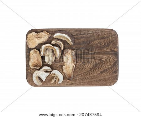 a dry mushroom on a cutting board isolated on white.