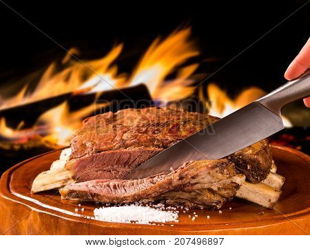 Barbecue ribs traditional Brazilian barbecue. fire background