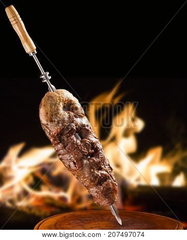Alcatra traditional Brazilian barbecue. fire in background
