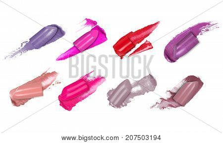 Set of colorful lipsticks smears with a slices of lipsticks closeup isolated on a white background