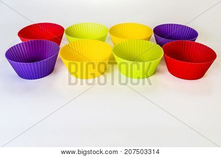 Mixed cupcakes multicolored on white background silicone