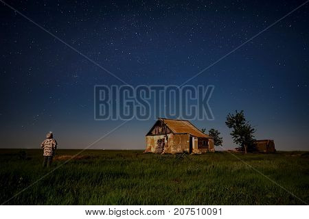 Abandoned haunted house for night horror scene with a man in front