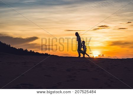 Fit Mother With Son Running At The Desert In Gran Canaria, Maspalomas On Sunset