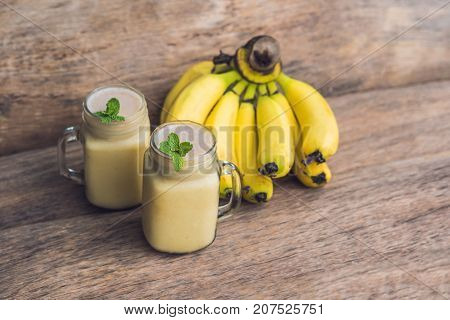 Banana Smoothies And Bananas On An Old Wooden Background