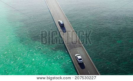 Two car drive pass on flyover bridge at sea Aerial view .