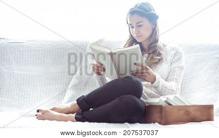 Girl Reading Book On Sofa