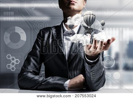Closeup of business woman in suit presenting flying aerostate among clouds in her palm with office view on background. 3D rendering.