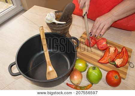 Chef cuts the vegetables into a meal. woman hands cutting vegetables on kitchen blackboard. Healthy food. Woman preparing vegetables