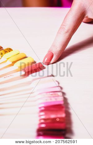 the girl chooses the color of Polish for manicure. testers nail Polish