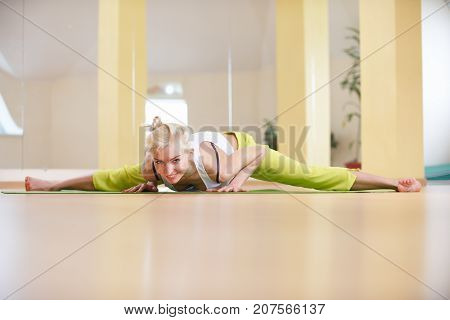 Beautiful sporty fit yogi woman practices yoga asana Samakonasana Straight angle pose in the yoga class