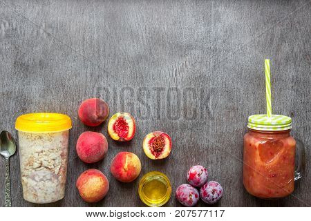 Fruit Smoothies. Peach and plum smoothie. Peach, plum and oatmeal. Delicious and healthy breakfast on wooden background. Top view. Copy space. Still life. Flat lay