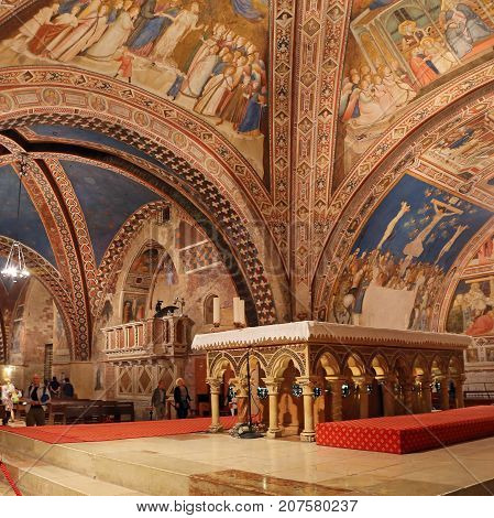 ASSISI ITALY 30 JUNE 2017: Interior Famous Basilica of St. Francis of Assisi (Basilica Papale di San Francesco) with Lower Plaza at sunset in Assisi Umbria Italy