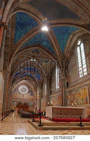 ASSISI ITALY 30 JUNE 2017: Interior Famous Basilica of St. Francis of Assisi (Basilica Papale di San Francesco) with Lower Plaza at sunset in Assisi Umbria Italy