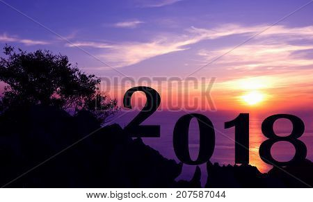 New year 2018 with sunset on the mountain silhouette background.