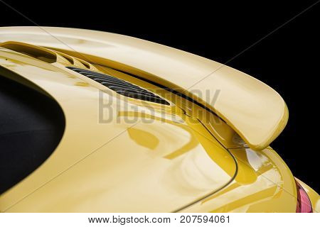 Close up on yellow sport car rear spoiler