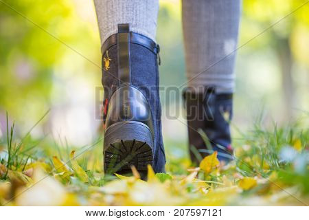 A Girl In Black Boots Trampled On Leaves, Autumn, Yellow Leaves On The Floor, Woman's Legs