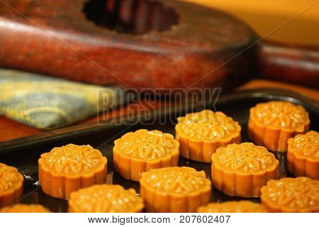close-up group of moon cake on metal tray and wooden mold, home made Moon cake, traditional dessert made from du-rian for Chinese mid autumn festival, gourmet asian restaurant
