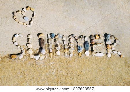 Inscription summer with heart on the background of the sea