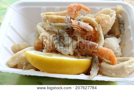 Appetizing Background Of Many Fish Fried In A Pan In The Street