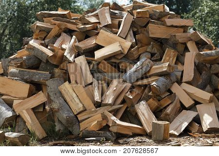 Dry chopped firewood stacked in a pile close up