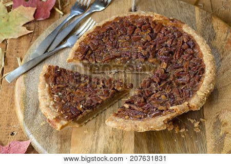 Sliced pecan pie on a wooden plater