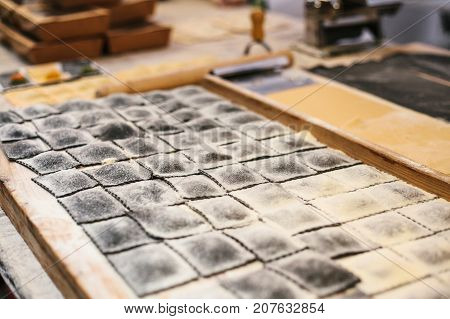 Preparation of Italian dish Ravioli. This is pasta from dough with different fillings. An analog of ravioli is dumplings. Kitchen background. National Food. Unprepared.