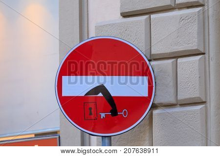 Road sign with an arm that comes out from signal street art metropolitan art