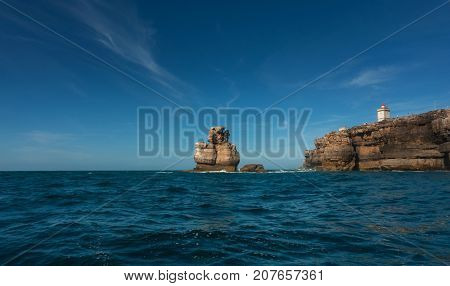 Nau dos Corvos and the Lighthouse of Peniche, Portugal. View from the ocean