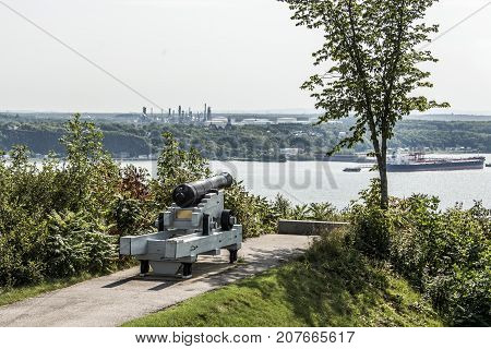 Cannon in Quebec City Canada - plaines Abraham overlooking Saint Lawrence river and Jean-Gaulin Refinery in Levis town