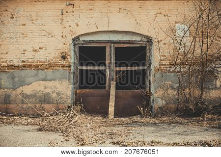 View of an old abandoned log house, finished with a plaster in a village.