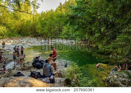 LYNN CANYON PARK, CANADA - JULY 3, 2017 : People visiting the 30 Foot Pool in Lynn Canyon Park in North Vancouver.