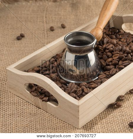 Square front view of coffee box with brown coffee grains