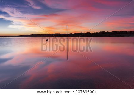 Pink sunset reflected in the lake  in Alava