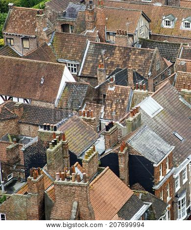 York, England, UK: June 20, 2015: Roof tops of old English buildings, taken from York Cathedral. Traditiional medieval roofs with clay tiles and