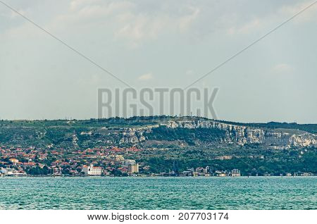 The Black Sea Shore, Green Hills With Houses, Blue Clouds Sky. City Balchik Coast