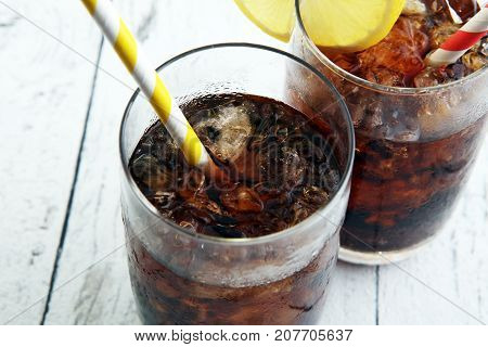 Softdrink With Ice Cubes, Lemon And Straw In Glass