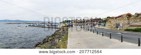 NESEBAR BULGARIA - AUGUST 21 2017: Panoramic view of the seaport and the ruins of the ancient fortress wall at the old town of Nesebar.