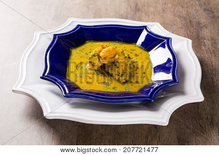 Pequi Fruit With Chicken Over A Wooden Table. Frango Com Pequi.