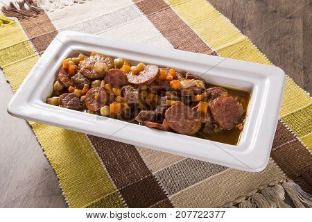 South American Cuisine: Puchero Soup With Sausage. Close-up In A Pot On The Table.