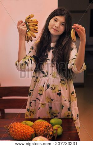 Teenager Girl With Mango Pineapple Mini Banana Tropical Fruit