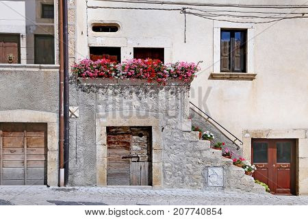 PESCOCOSTANZO ITALY - AUGUST 21 2015: Nice facades in steep alley. The mountain village - about 1400 m above sea - Pescocostanzo in the region of Abruzzo Italy