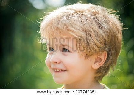 Happy child portrait boy smiling and looking away. Smile and happiness happy childhood. Child's face close up. People Portrait. Funny little boy 3 years old. Portrait beautiful blond preschool kid