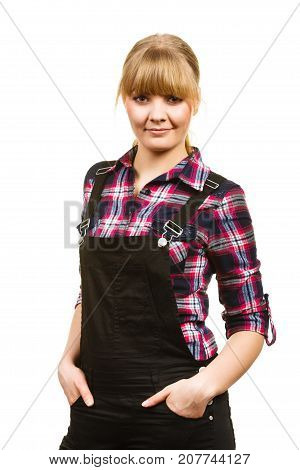 Gardening fahion concept. Smiling attractive woman in pink check shirt and dungarees hands in pocket. Isolated background